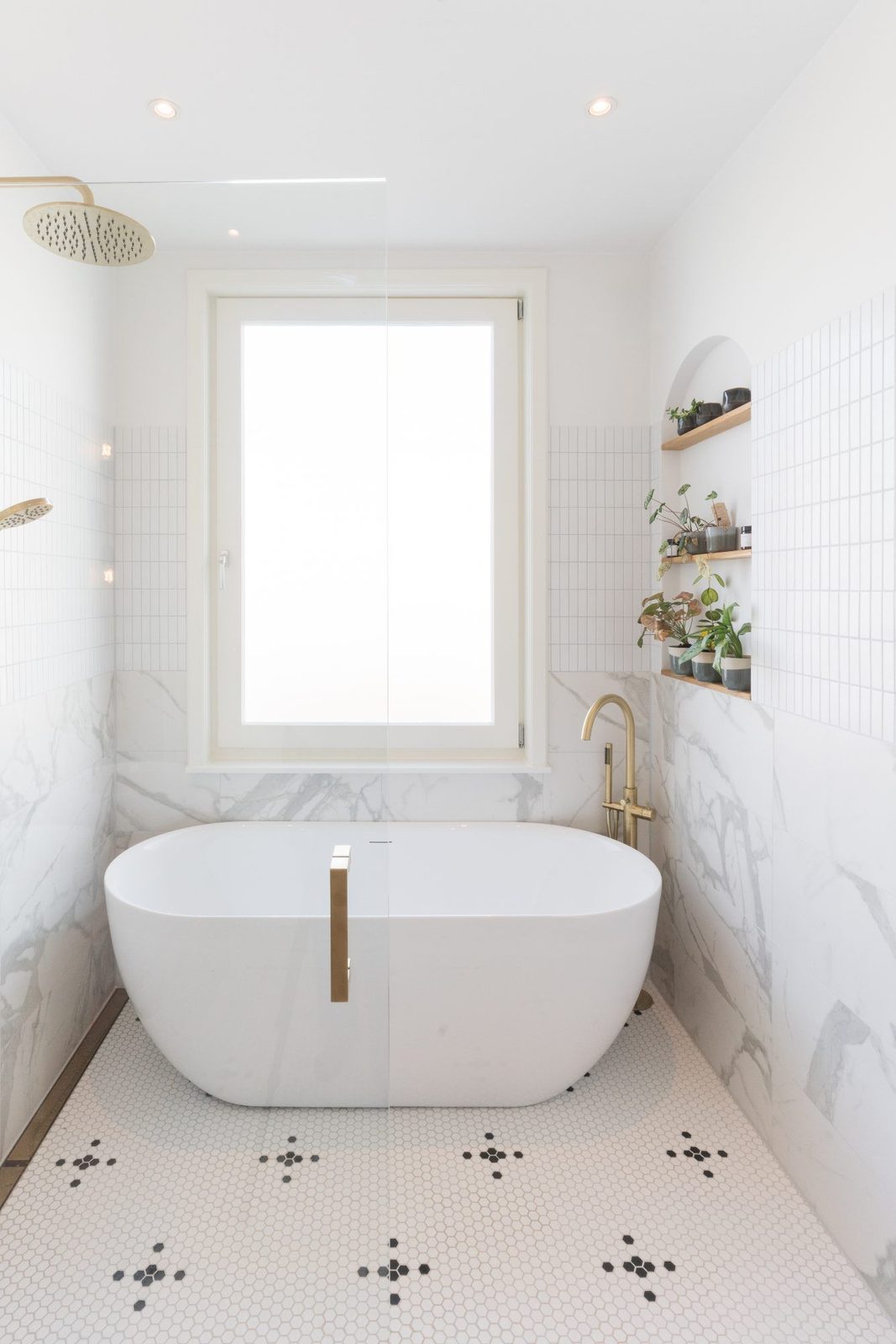 Bathroom with freestanding bath, marble and brass taps