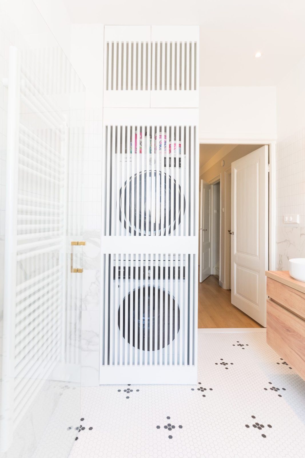 Lacquered cabinet concealing the laundry next to the bathroom